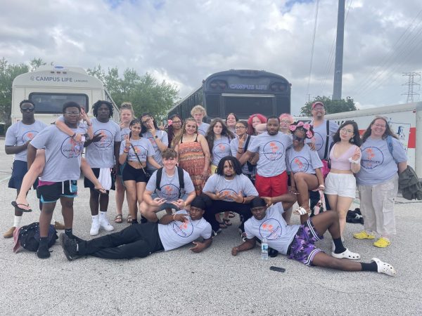 Posing for a picture, Karis Hayes fourth in from the left stands with fellow campers from Lake Aurora. Lake Aurora is a Christian camp that attended over spring break